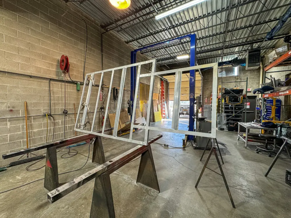 Diamond-plate body and step detail in production, photo 138 of 303.